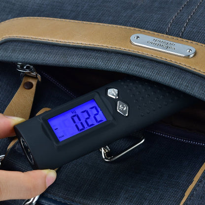 Digital luggage scale being used on a blue bag with a visible brand name.