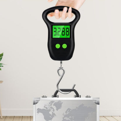 Digital hanging scale with a hand holding it above a suitcase on a light background